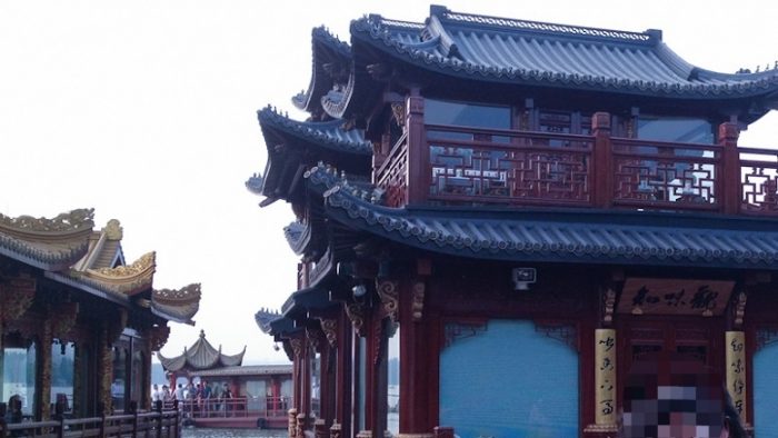 Paviliun dengan atap pagoda dan railing kayu bergaya tradisional China melambangkan The Harmony of West Lake Hangzhou