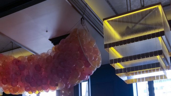 Hiasan balon warna oranye,kjuning dan putih didampingi lampu unik