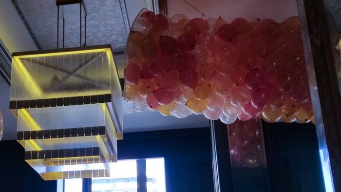 Hiasan balon warna oranye, kuning dan putih di The Lounge Bar
