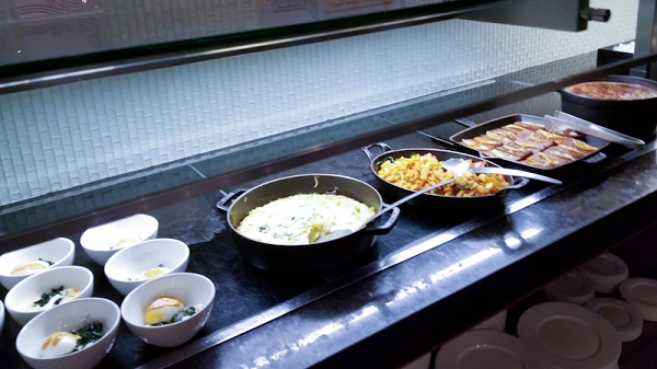 Breakfast table with food offerings such as The famous French Toast at The Centurion Lounge LGA 