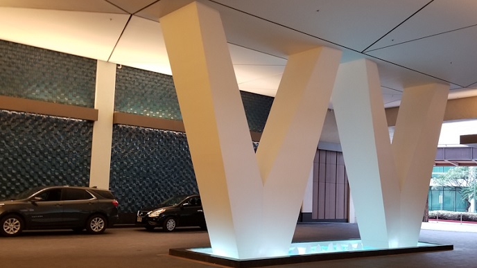Two column with V letter and a small pool with water fountain