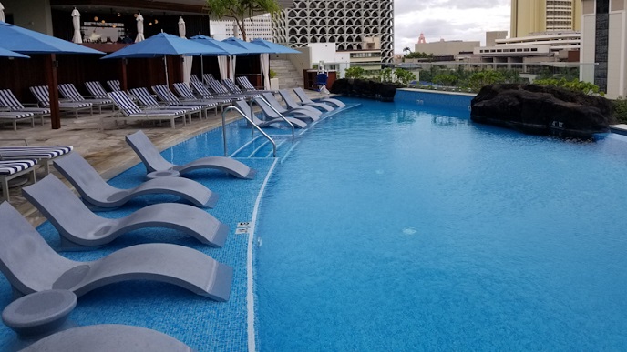 The Ritz-Carlton Waikiki swimming pool Family pool with lounge chairs