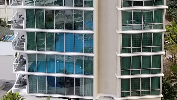 Swimmin pool reflection on the glass wall