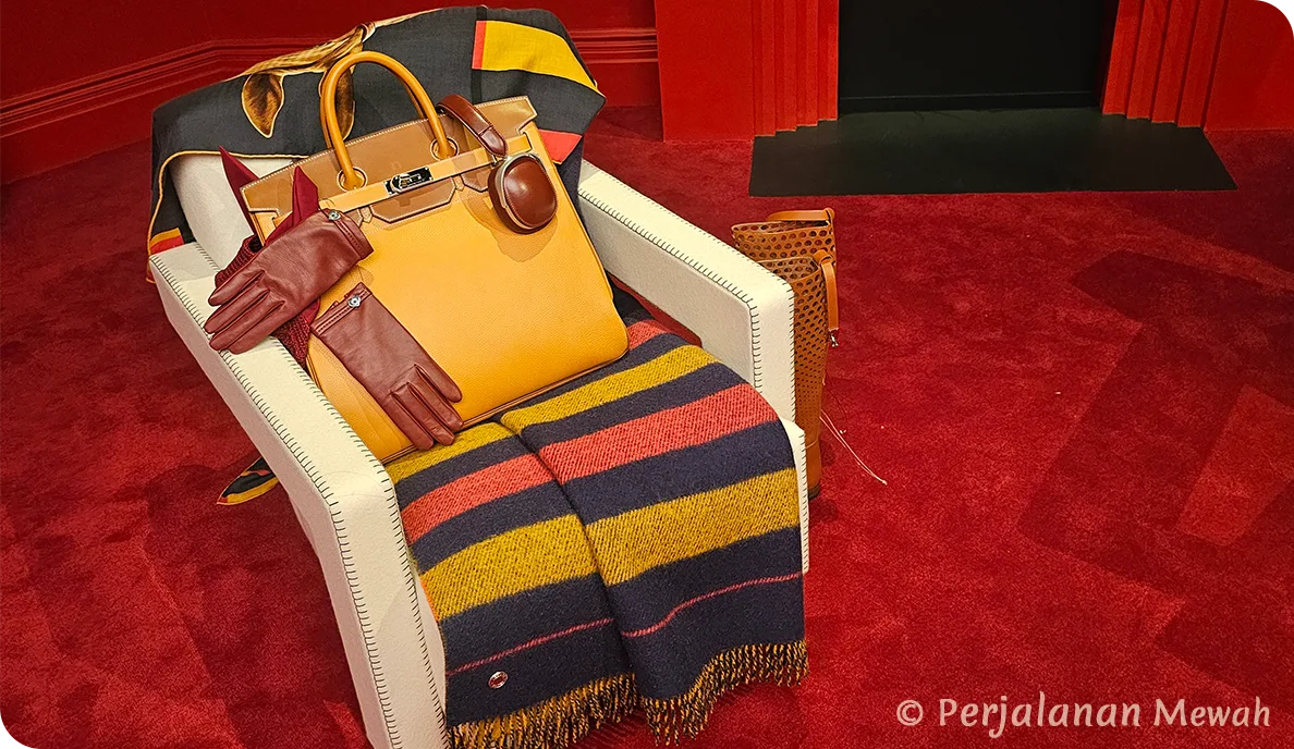 Hermès Birkin bag with leather gloves and headphones resting on a striped blanket in the Head Groom’s Office
