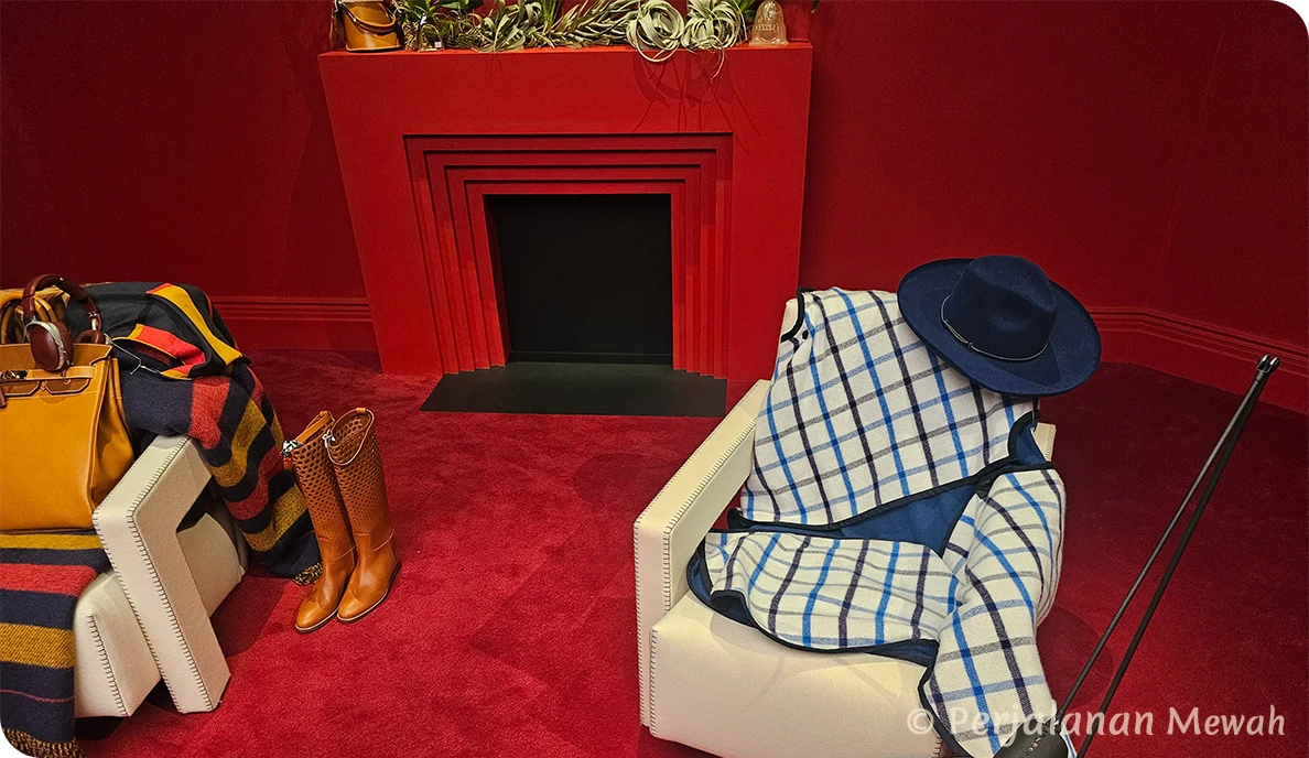 Hermès wool blanket and navy hat draped on chair near fireplace in the Head Groom’s Office