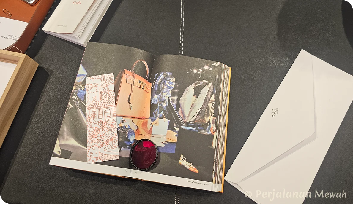 Hermès equestrian-themed book and white envelope displayed on dark leather desk in the Head Groom’s Office