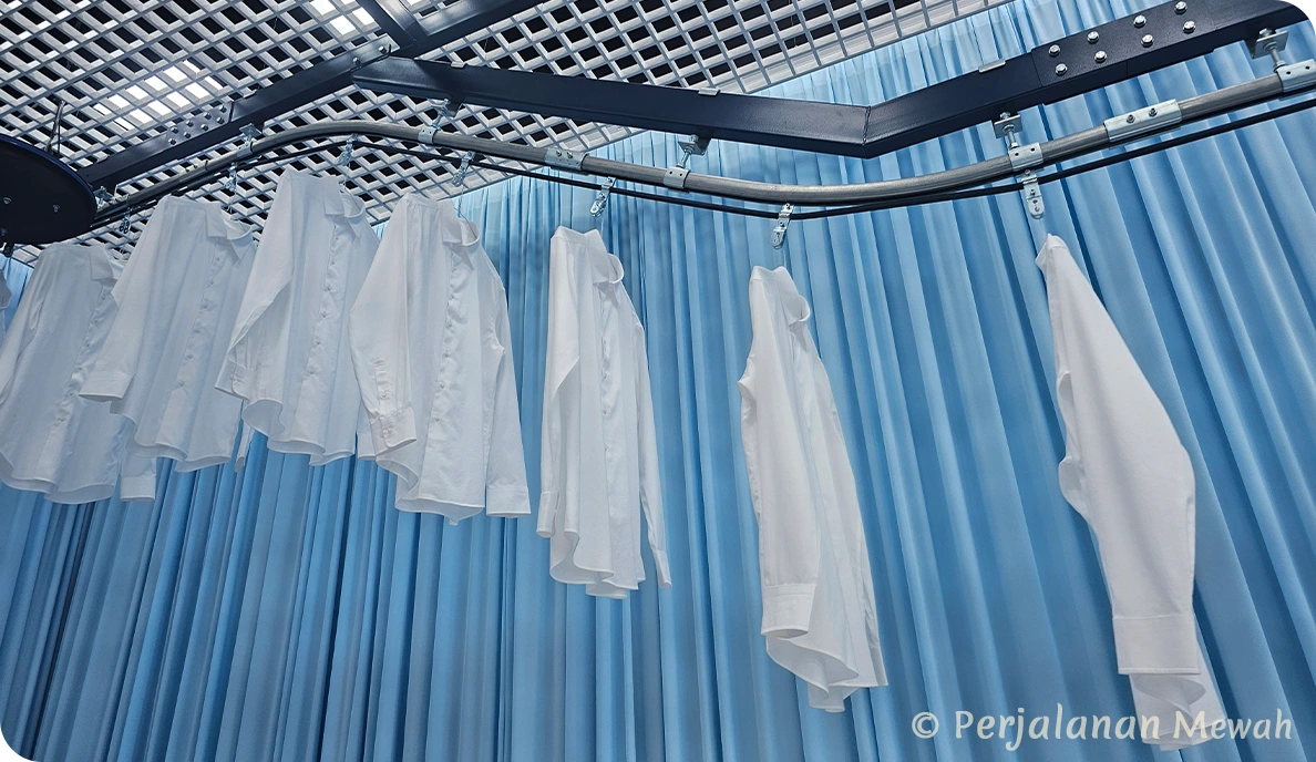 Hermès white shirts hanging on rails in Laundry room